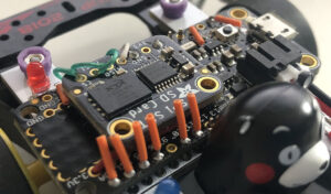 AI Mini 4WD with an Adafruit XTSD module mounted on top of Adafruit Feather M0 Basic Proto microcontroller